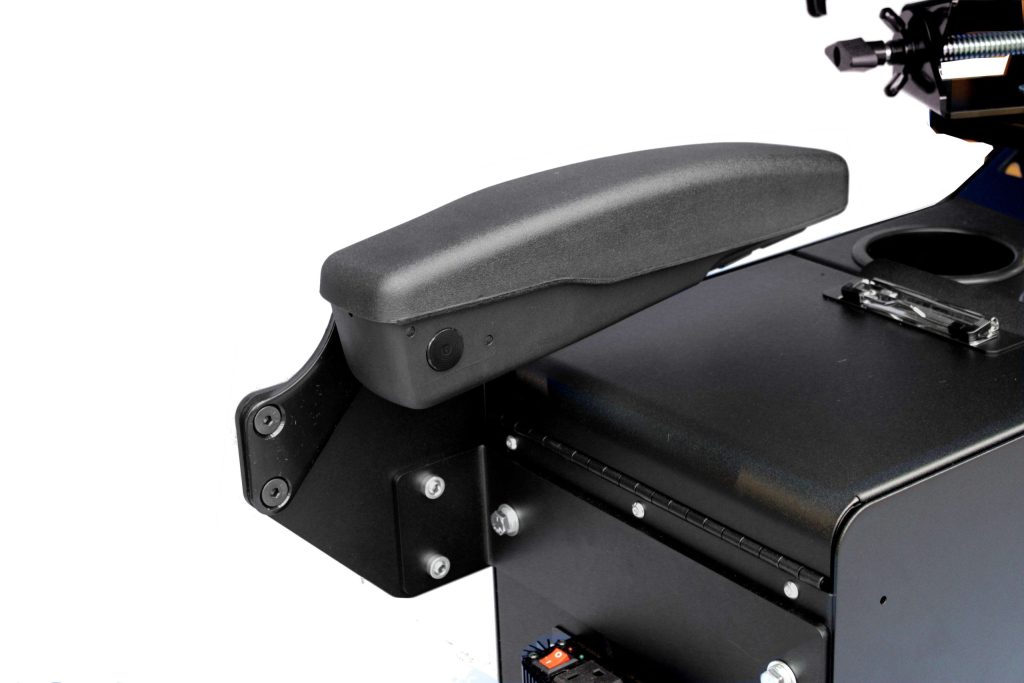 Black plastic armrest attached to the side of a metal office chair or equipment housing against a white background.