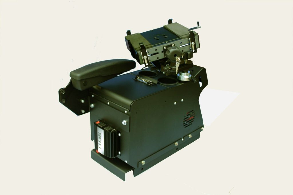 A black, box-shaped mechanical device with an armrest, control levers, and various dials and components.